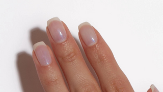 Hand with a clear, shimmery, and gloss manicure, otherwise known as Lip Gloss Nails