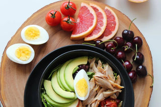 An assortment of healthy fruits, vegetables, eggs, and meats