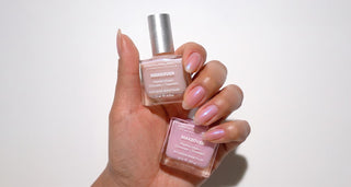 Manicured hand holding two shades of Dermelect Makeover Smoothing Ridge Filler.